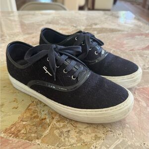 Navy blue Ferragamo sneakers with patent leather trim.